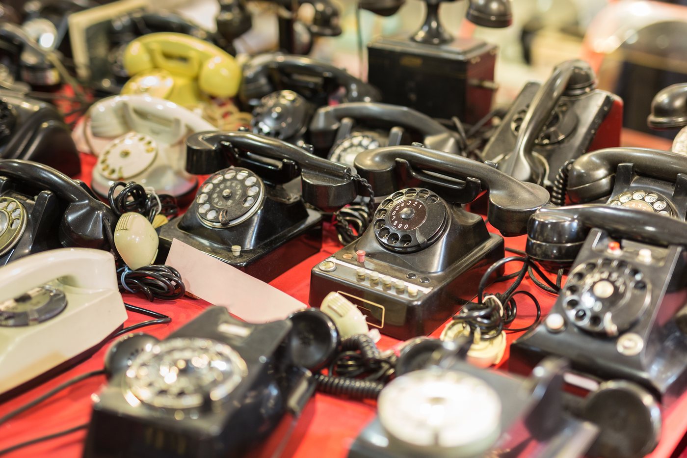 Collection of outdated rotary dial telephones representing aging government phone equipment