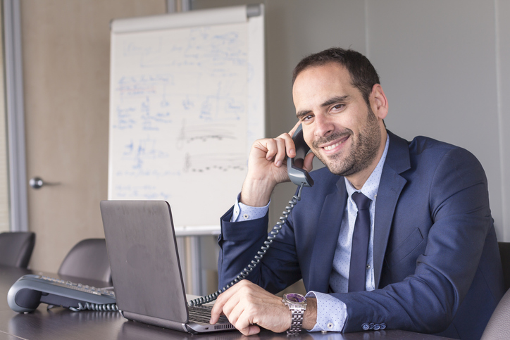 An insurance agent on a call at the office